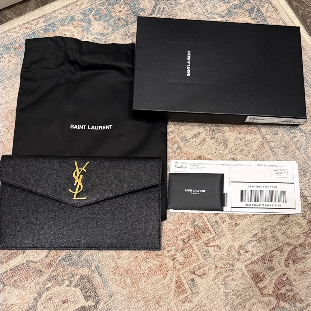 Saint Laurent Black and Gold women’s pouchette clutch